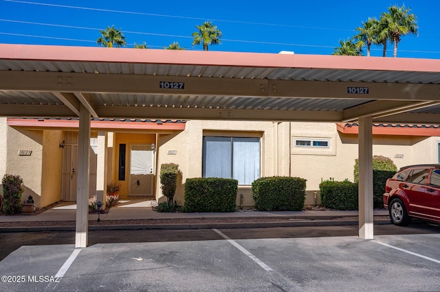 view of vehicle parking with a carport