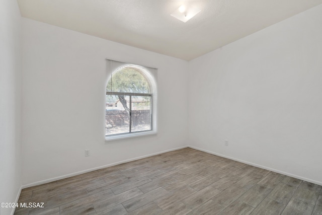 spare room featuring light hardwood / wood-style flooring