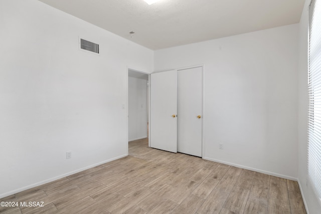 unfurnished bedroom with light wood-type flooring