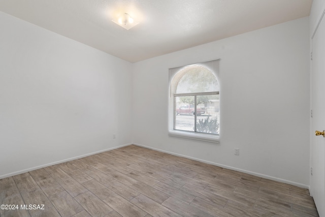 spare room featuring light hardwood / wood-style floors