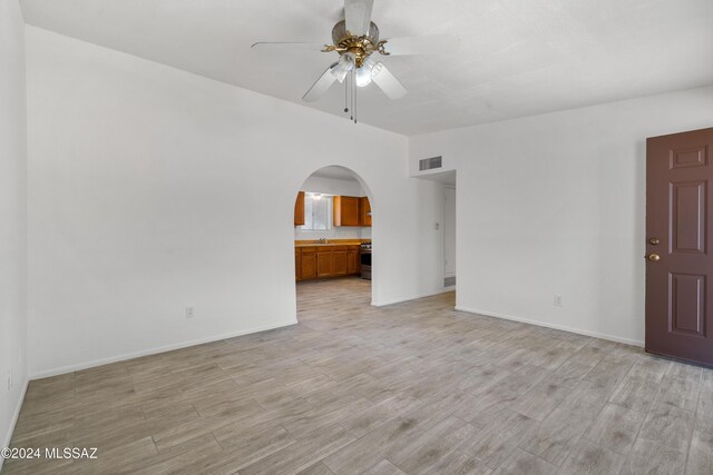 spare room featuring ceiling fan and light hardwood / wood-style floors