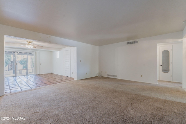 empty room featuring ceiling fan and carpet