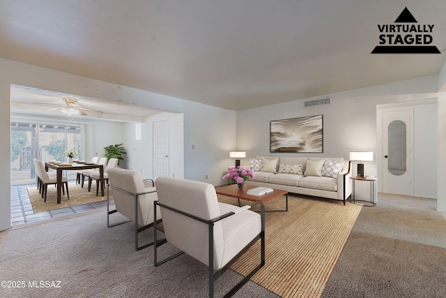 carpeted living room with ceiling fan