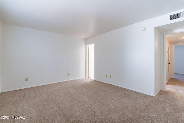 spare room featuring light colored carpet