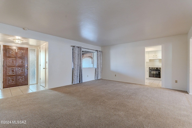 unfurnished living room with light carpet