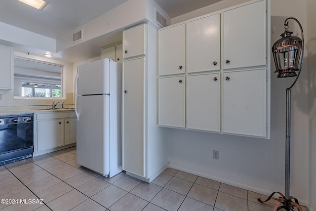 kitchen with dishwasher, white fridge, white cabinets, and sink