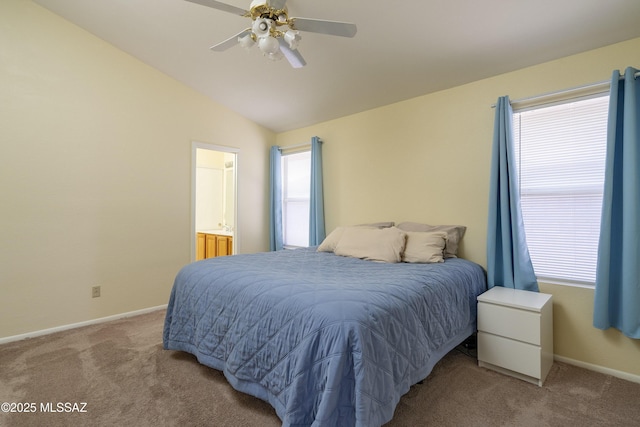 bedroom featuring carpet flooring, ceiling fan, ensuite bathroom, and lofted ceiling