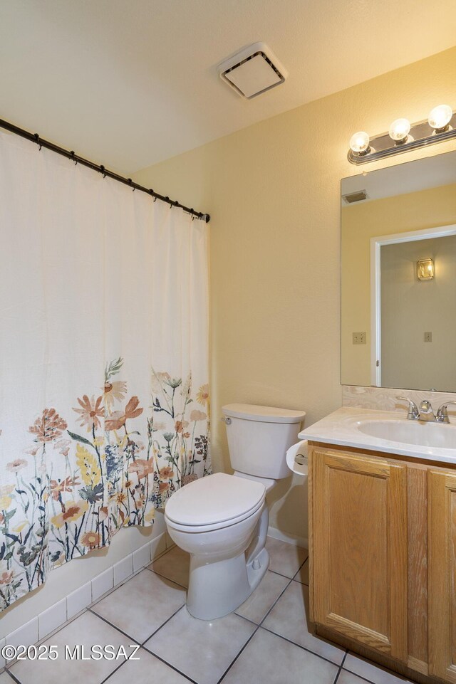 full bathroom featuring tile patterned flooring, shower / tub combo, vanity, and toilet