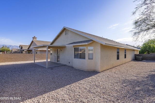 exterior space featuring central air condition unit and a patio