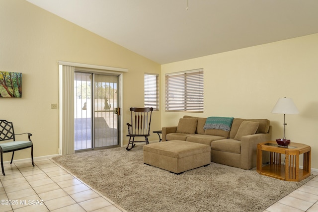 living room featuring lofted ceiling and light tile patterned floors