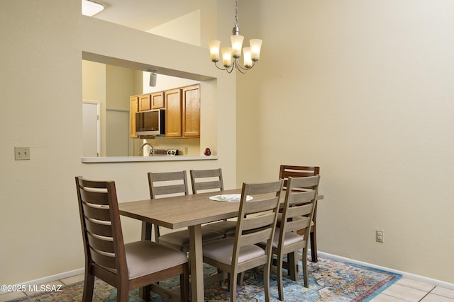 tiled dining room with a chandelier and sink