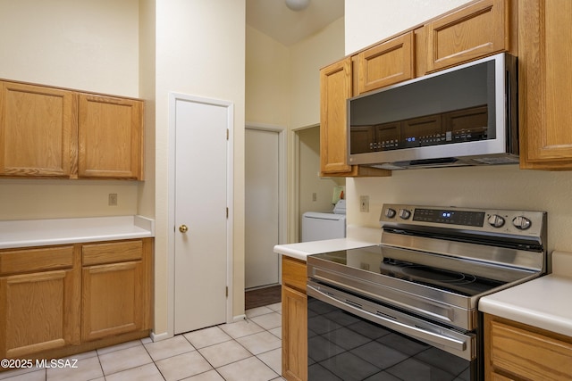 kitchen with light tile patterned floors and stainless steel appliances