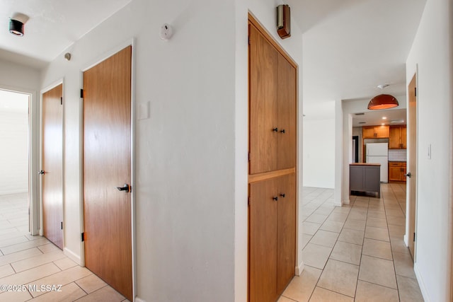 corridor with light tile patterned flooring