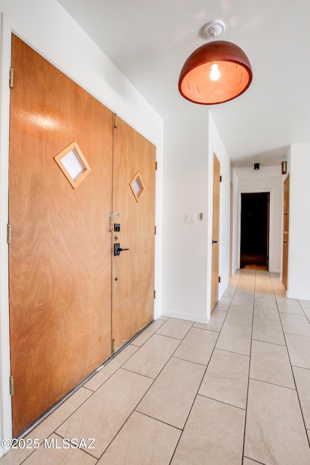 entryway with light tile patterned floors