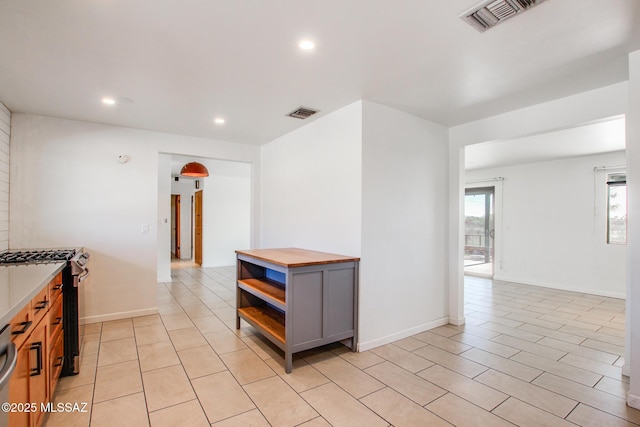 kitchen with gray cabinets and appliances with stainless steel finishes