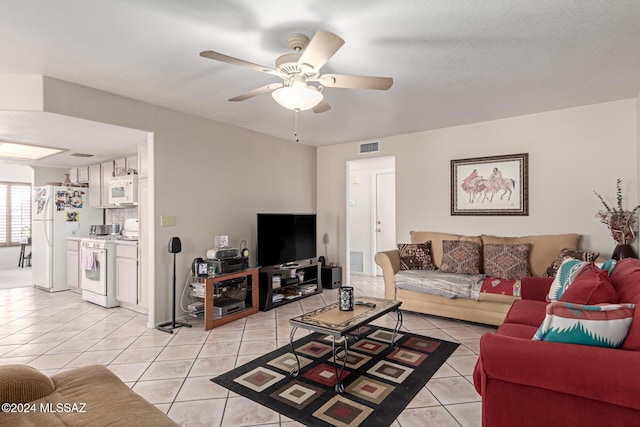 tiled living room with ceiling fan