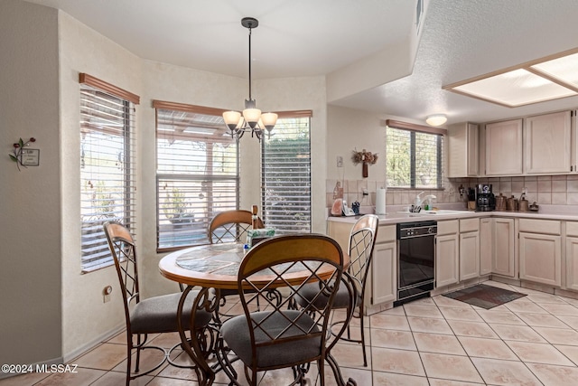 tiled dining space featuring sink and an inviting chandelier