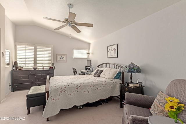 bedroom with light colored carpet, vaulted ceiling, and ceiling fan