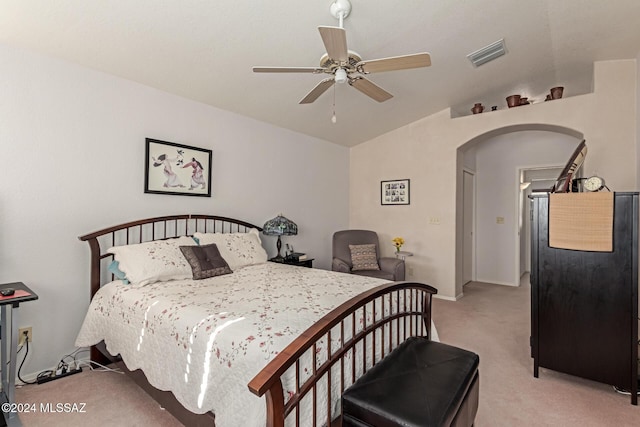 bedroom featuring light carpet, vaulted ceiling, and ceiling fan