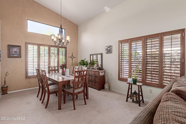 dining space with a notable chandelier, light carpet, and high vaulted ceiling