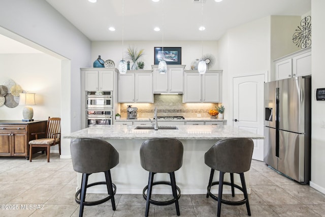 kitchen featuring white cabinetry, a kitchen island with sink, and appliances with stainless steel finishes