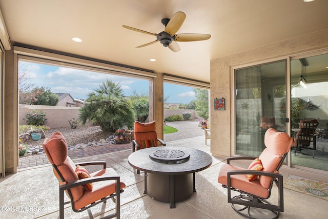 view of patio with a fire pit and ceiling fan