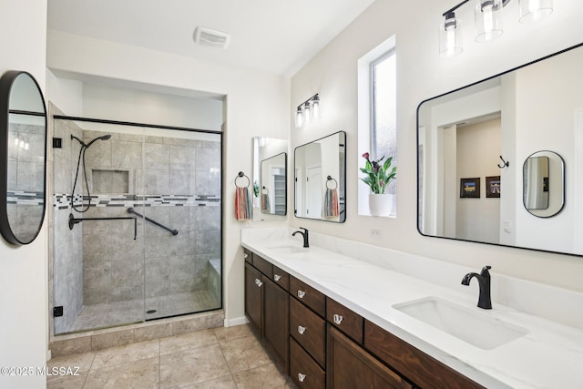 bathroom with tile patterned flooring, vanity, and an enclosed shower