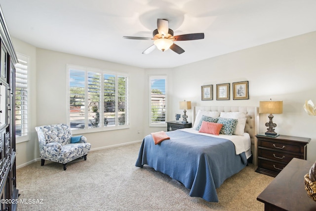 bedroom with ceiling fan and light carpet