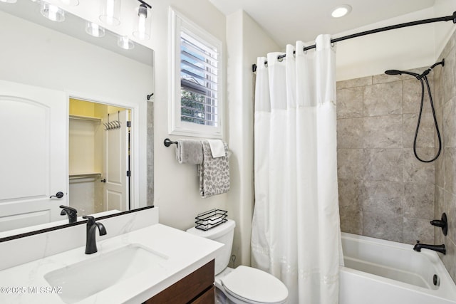 full bathroom featuring shower / bath combo with shower curtain, vanity, and toilet