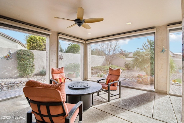 sunroom featuring ceiling fan