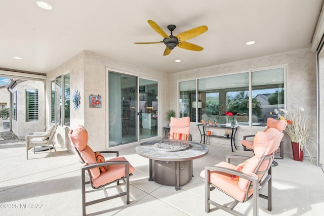 view of patio / terrace with a fire pit and ceiling fan