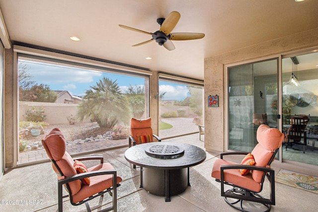 sunroom / solarium featuring ceiling fan