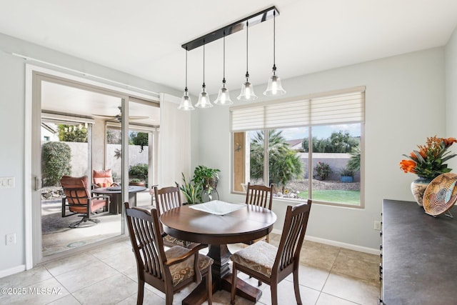 tiled dining area featuring ceiling fan