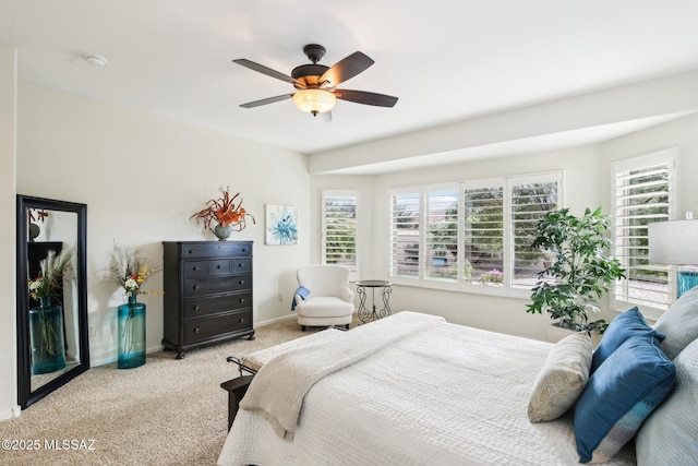 bedroom with ceiling fan and light carpet