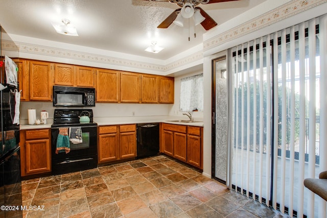 kitchen with black appliances, ceiling fan, a healthy amount of sunlight, and sink