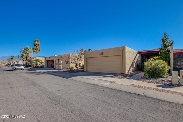 pueblo-style home with a garage