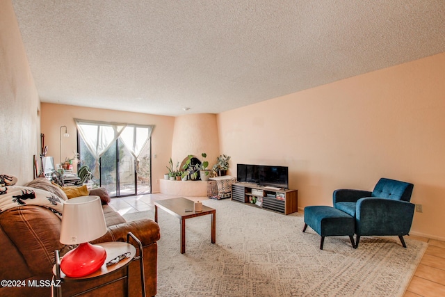 living room featuring light tile patterned floors and a textured ceiling