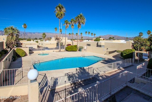 view of swimming pool featuring a patio area and a mountain view