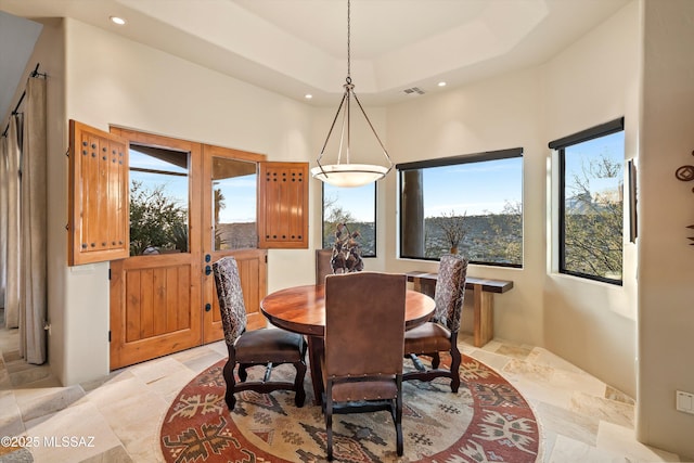 dining space featuring a raised ceiling