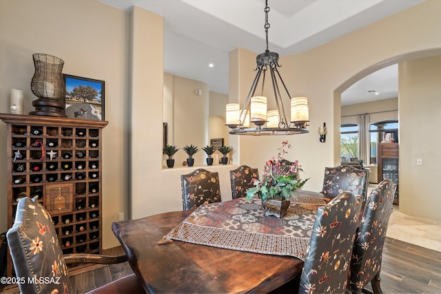 dining area with dark hardwood / wood-style flooring and a chandelier