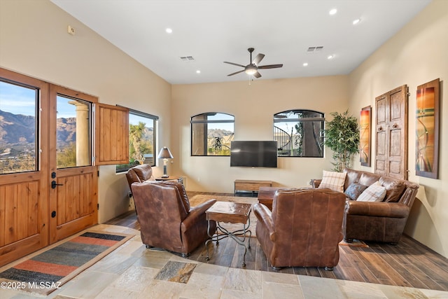 living room featuring ceiling fan and hardwood / wood-style flooring