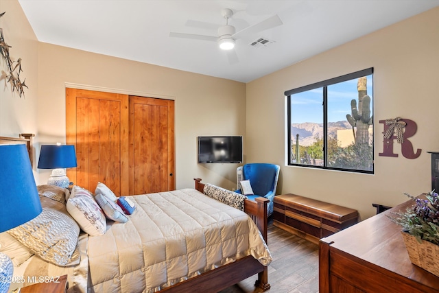 bedroom with a closet, ceiling fan, and hardwood / wood-style floors