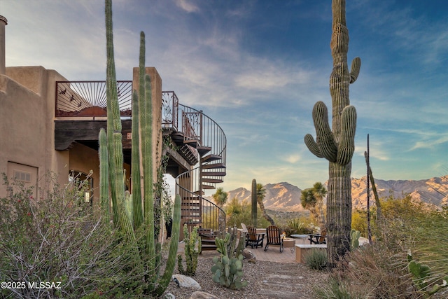 view of property's community featuring a mountain view and a patio