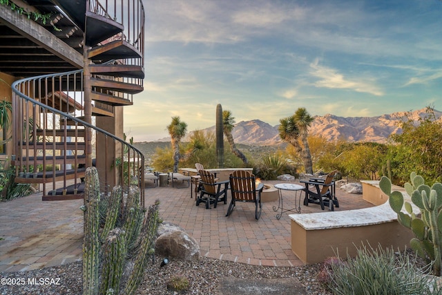 patio terrace at dusk with a mountain view