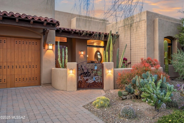 view of exterior entry at dusk