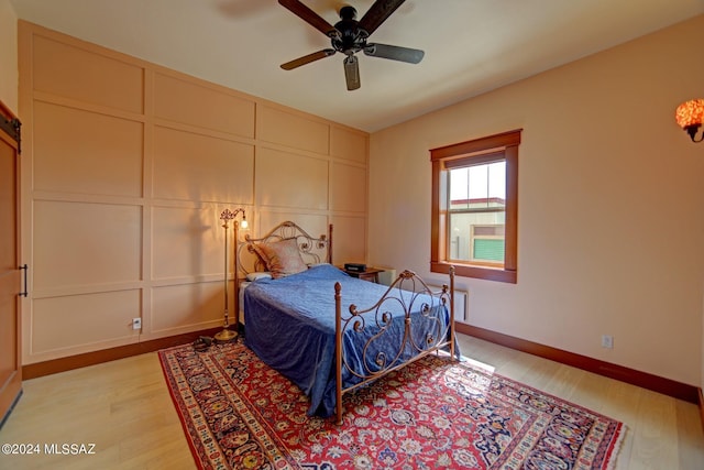 bedroom featuring light hardwood / wood-style flooring and ceiling fan