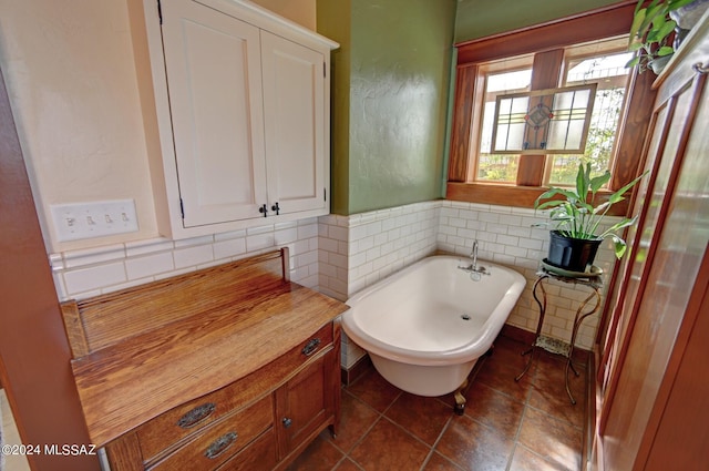 bathroom with tile patterned flooring and a bathtub