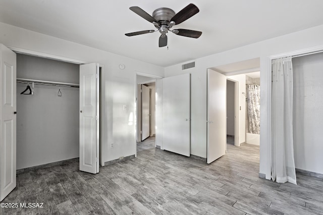 unfurnished bedroom featuring ceiling fan, a closet, and hardwood / wood-style flooring