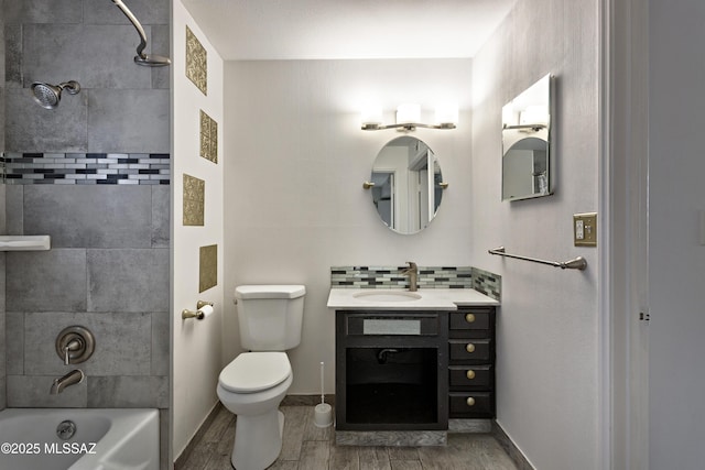 full bathroom featuring vanity, toilet, decorative backsplash, and tiled shower / bath