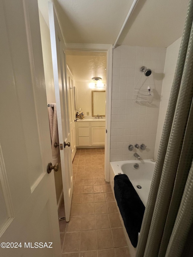 bathroom featuring tile patterned flooring, vanity, and shower / bathtub combination with curtain